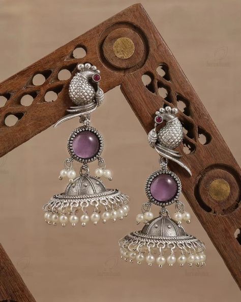 Parakeet Parrot Jhumki Earrings from Elitefashions will add a swanky twist to your Jewelry collection. Match this  pair with a your basic outfit to turn your basic look into a fashionable look. Silver pairs can be matched with dark wash jeans, a beautiful top, and patent pumps for a stellar brunch outfit and greatly compliments the traditional outfits. Rs 699 only DM to order Fancy Earrings Classy, Oxidized Jewellery, Temple Jewellery Earrings, Xxxtentacion Quotes, Bangle Design, Indian Wedding Jewelry Sets, Ear Pieces, Bride Jewelry Set, Creative Jewelry Photography