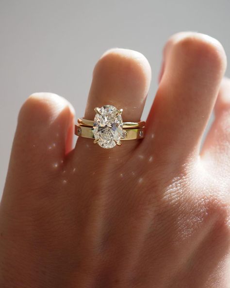 Kate & Kole | The perfect pairing — Our Clara 3.09ct Oval Solitaire Engagement Ring paired perfectly alongside our newest addition to our Wedding Band… | Instagram Thick Wedding Bands, Gold Band Engagement Rings, Thick Gold Band, Oval Solitaire Engagement Ring, Stacked Wedding Bands, Celestial Ring, Cute Engagement Rings, Future Engagement Rings, Oval Diamond Engagement