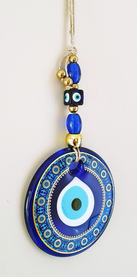 Protect your home with the mesmerizing beauty of the Modern Evil Eye Wall Hanging 🧿✨ A symbol of amulet and Turkish tradition, this Greek Eye brings luck and wards off negative energies 🙏🏼💙 Add a touch of culture and style to your space with this stunning Nazar Boncuk 🏠💫 #EvilEye #TurkishTradition #GreekCulture #Amulet #Protection #BlueEye #BeautifulDecor Modern Evil Eye, Evil Eye Wall Decor, Eye Wall Decor, Evil Eye Wall Hanging, Greek Eye, Turkish Eye, Turkish Evil Eye, Mesmerizing Beauty, Blue Eye