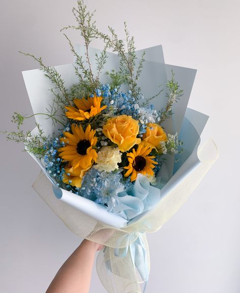 Sunny skies is the vibe. A fun mix of sunflowers, yellows, blues, whites and touches of greenery. Images shown are examples and can differ depending on the supply and season. Sunflower Flower Bouquet, Mix Flower Bouquet, Flowers Sunflowers, Blue Sunflower, Blue Yellow Flowers, Blue Flowers And Sunflowers, Yellow And Blue Flowers, Sunflower Bouquet Gift, Sunflower Bouquet Aesthetic