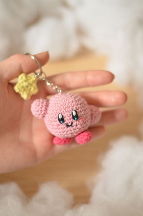 Are you a Nintendo fan or do you know someone who loves Kirby? It's time to make your cute Kirby keychain! The pattern is well-explained, easy to follow with pictures, and will definitely give you a dreaming Kirby! *PLEASE NOTE THAT THIS IS A CROCHET PATTERN (PDF file), NOT THE FINISHED KIRBY*. The file will be available for download immediately after purchase (8 pages of detailed instructions) This crochet pattern doesn't contain the crocheting lessons. You should have the basic crochet skills. Crochet Kirby Keychain, Free Pattern Keychain Crochet, Pink Crochet Keychain, Pink Crochet Pattern, Crochet Anime Keychain, Crochet Keychain Cute, Crochet Kirby Free Pattern, Crochet Pink Ideas, Kirby Crochet Pattern Free