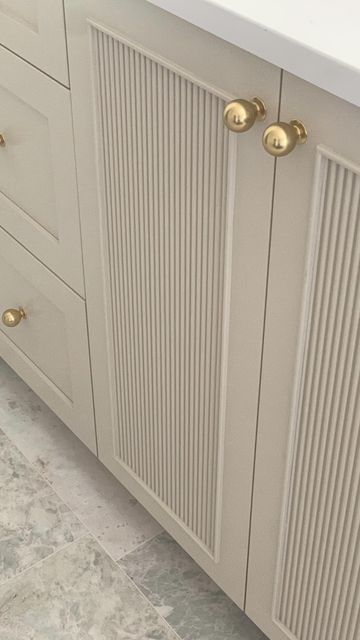 Fluted Vanity Cabinet, Painted Reeded Cabinets, Creamy White Bathroom Cabinets, Reeded Cabinets Kitchen, Fluted Built In Cabinets, Spanish Style Bathroom Ideas, Fluted Cabinet Kitchen, Reeded Cabinet Door, Reeded Kitchen Cabinets