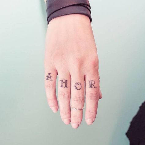 Word ‘AMOR’ inked on the right hand’s fingers Cool Tattoo Designs, Finger Tattoos Words, Amor Tattoo, Portuguese Words, Cage Tattoos, Belly Tattoos, Ribcage Tattoo, Knuckle Tattoos, Finger Tattoo Designs