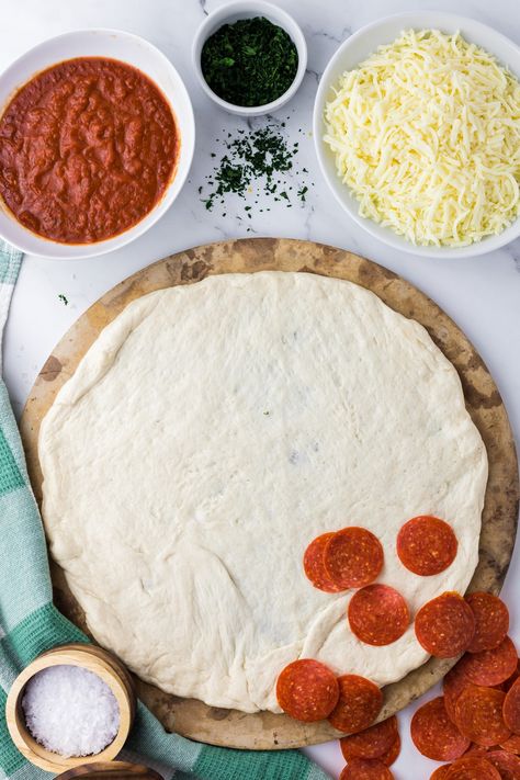 Learn how to make homemade pizza with store-bought dough. If you love a delicious homemade pizza, this recipe is a great alternative to making pizza dough from scratch. All you need is about 30 minutes, your favorite toppings, and store-bought pizza dough. Homemade Pizza Store Bought Dough, Pizza From Store Bought Dough, Best Store Bought Pizza Dough, Store Bought Pizza Dough How To Use, Pizza Recipes With Store Bought Dough, Homemade Pizza With Store Bought Dough, Pilsbury Pizza Dough Recipe, Peperoni Pizza Recipes, Pizza With Store Bought Dough