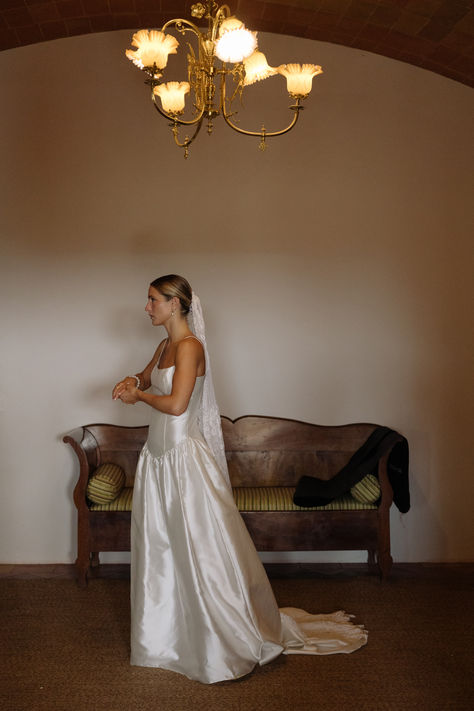 A sun-soaked celebration for Gemma and Jake against the backdrop of Mas Sendra in Spain. For her dress Gemma chose STYLE 075, our beautiful drop waist silk mikado gown with a square neckline and delicate straps. We love Gemma's additional styling touches; customising the back to a lower v and adding a vintage lace veil and pearl hair net, in a nod to her spanish heritage. Read more about this real wedding on the blog. #modernweddingdress #simpleweddingdress #coolbride #bespokeweddingdress V Waist Wedding Dress, Mikado Gown, Waist Wedding Dress, Real Bridesmaids, Drop Waist Wedding Dress, Girona Spain, Spanish Heritage, Contemporary Bridal, Indie Wedding