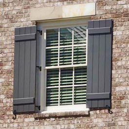 greyish blue board and batten shutters hinged on brick Shutters Before And After Exterior, Outdoor Shutter Paint Colors, Real Shutters Exterior, Exterior Window Shutters On Brick, Modern Outdoor Shutters, European Shutters Exterior, Window Shutters Exterior Brick House, Gray Shutters Brick House, Board And Batten Shutters Exterior