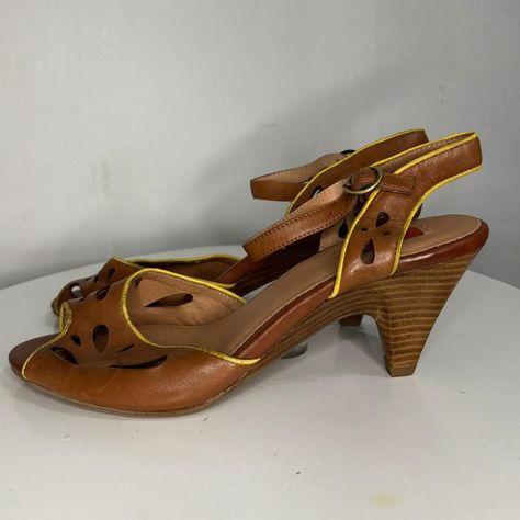 Brown Miz Mooz Sandals with Yellow Piping, Size 10. Beautiful cutout leather design with a unique yellow trim. Adjustable buckle closure for a secure fit.

Brand: Miz Mooz
Size: 10 US
Material: Brown leather with yellow trim
Design Features: Intricate cutout pattern, ankle strap with buckle, open-toe
Condition: Pre-loved (amazing condition, as seen in photos)
Heel Type: Block

These comfy and chic sandals are perfect for summer looks!