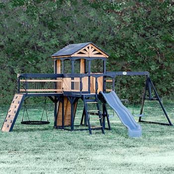 Backyard Discovery Timber Crossing Swing Set | Costco In Ground Trampoline And Playground, Diy Outdoor Swingset Play Structures, Backyard Play Structure, Kids Swingset Ideas Diy, Modern Outdoor Playground, Kids Playset Outdoor Diy, Wooden Playground Ideas, Diy Playset Outdoor Plans, Kids Swingset Ideas