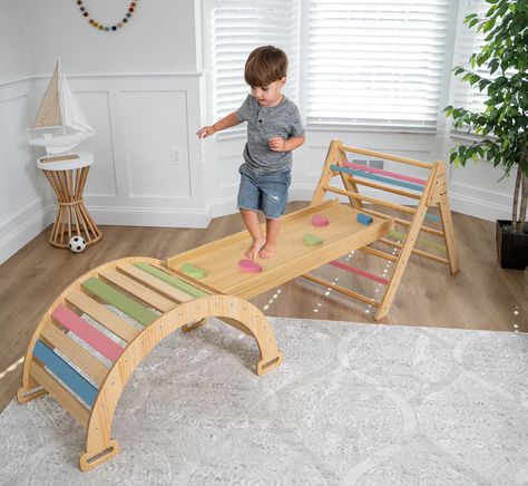 This Ultimate Climbing Set is the perfect way to develop independence and imagination! It's a Montessori climbing structure that can become a castle, a garage, or anything else the kids imagine. Made with high-quality natural wood and BPA-free paint, it's sturdy and safe. The set is foldable and easy to store. Packed full of fun with 4 different activities - Arch Ramp, Slide, Rocker, and Triangle Rock Climber. Slide Playground, Indoor Playset, Climbing Structure, Indoor Climbing Gym, Montessori Climbing, Toddler Gym, Climbing Triangle, Pikler Triangle, Indoor Gym