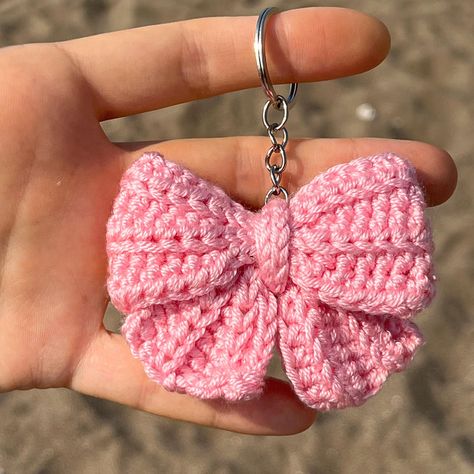 Cute Crochet Pink Coquette Bow Keychain Each toy is handmade by me and made to order. ✅SHIPPING Fast shipping - It will take 1-5 business days to print and ship 🚀 💚Each product is packed and shipped to you with lot of love and care 🧶Acrylic ✅SIZE Approx 5 cm width. ✅CARE INSTRUCTIONS - Wash by hand only. Soak in warm, soapy water without scrubbing. Allow to air dry. Avoid machine washing. - Do not bleach or iron. ✨Thank you so much for visiting my shop! If you have any questions, please feel Cute Crochet Things To Sell, Crochet Bag Decoration, How To Crochet A Keychain, Tiny Things To Crochet, Crochet Bag Keychain, Crochet Keychain Cute, Crochet Bow Keychain, Handmade Crafts Ideas Creative, Crochet Party Favors