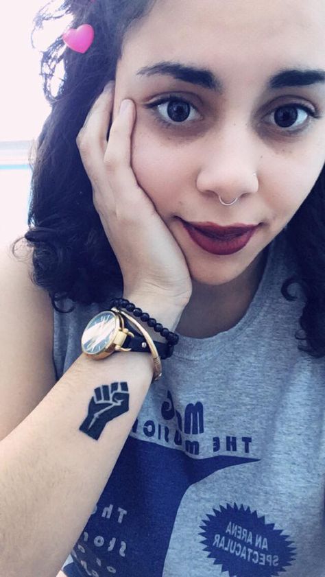 Minimalist Black Lives Matter Tattoo -- black power fist on wrist for women or men Interracial Tattoos, Black Empowerment Tattoos, Black Power Tattoo For Women, Black Pride Tattoo, Black Activist Tattoos, Blm Tattoo Ideas, Black Excellence Tattoo, Black Power Tattoo, Black Lives Matter Tattoo