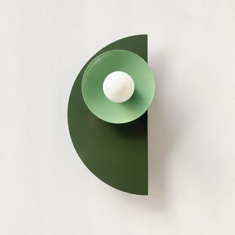 The Kin Sconce is a simple, adjustable geometric wall sculpture that can be in neutral tones of brass and black or bright, colorblocked colors. Measurements & Information: 11.5" Height (top of semi-circle to the bottom), 6" Wide 3.25" depth (wall to edge of socket cup) 5" diameter wall plate Does not include bulbs. Recommended bulb: E26 screw base, 60W or less. We photographed it using a G16.5 E26. Unfortunately this fixture cannot be converted into a plug in fixture Care: Wipe with soft, clean, Sazerac, Bright Walls, Lighting Showroom, Bathroom Sconces, Mid Century Wall, Modern Light Fixtures, Wall Sculpture, Geometric Wall, Wall Plate