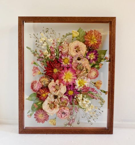 This is the perfect option for brides who have bouquets that are already dried! I can also use fresh flowers to create these frames. This frame is a high quality solid wood frame in a dark walnut finish. It measures 11x14 inches. The Process: 1.Message me prior to purchasing to reserve your date and inquire about availability.  2.Ship me your flowers! Detailed instructions on how and where to ship them will be sent to you once your reservation is made. I will also send a link to an information sheet that should be printed and included in the box with the flowers. Your flowers can be fresh or previously dried for this frame!  3.I will message you to let you know when your flowers arrive safely. If you send fresh flowers, they will dry over 8-10 weeks on my flower press, and I will watch ove Framed Pressed Flowers Wedding Bouquets, Pressed Flowers Framed With Picture, Pressed Flowers Wedding Bouquet, Pressed Flower Shadow Box Ideas, Best Flower Press, Pressed Floral Bouquet, Bouquet Frame Dried Flowers, Flower Press Frame, Diy Bouquet Preservation