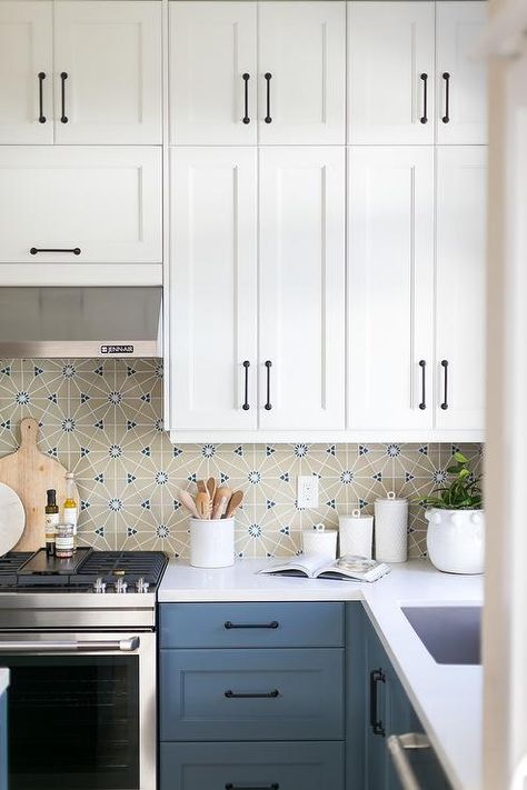 Blue kitchen drawers accented with oil rubbed bronze pulls and a white quartz countertop fixed against beige and blue mosaic backsplash tiles. White Upper Cabinets Blue Lower, Blue Lower Kitchen Cabinets, White Upper Cabinets, Top Kitchen Cabinets, White Cupboards, Bronze Pulls, White Shaker Kitchen, Blue Kitchen Cabinets, White Shaker Cabinets