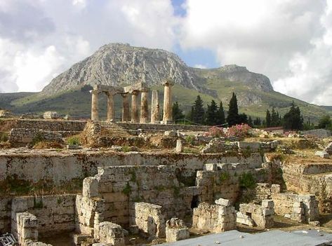 Ruins of the ancient city of Corinth lie between the Greek mainland and the Peloponnese peninsular region in southern Greece. You’ll find only a few Doric columns from the 6th-century temple of Apollo standing tall here, but the landscape is breathtaking. This ancient metropolis saw its fall after a massive raid by the Ancient Romans, who also went on to enslave its people. (Go Guide) Ancient Corinth, Bible Archeology, Corinth Greece, Temple Of Apollo, Turkey Trip, The Apostle Paul, Biblical History, Greece Pictures, Apostle Paul