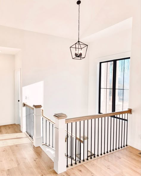 Modern Farmhouse Staircase Lighting, Open Floor Plan With Basement Stairs, Open Staircase Lighting, Stair Railing To Basement, Farmhouse Staircase Lighting, Upstairs Stair Railing, Farmhouse Stairs Railing, Railing At Top Of Stairs, Entryway With Stairs To Basement