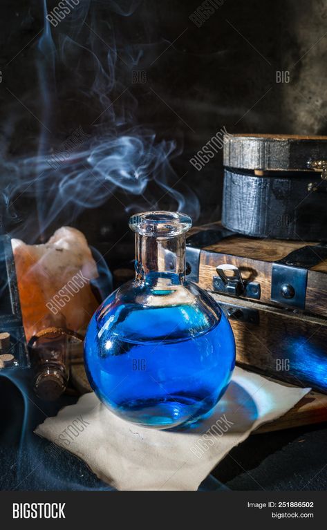 picture of Magic Concept. Blue Potion In Bottle, Candle, Old Wooden Boxes And Smoke. Magical Background stock photo Magical Background, Magic Concept, Magic Store, Old Wooden Boxes, Bottle Candle, Magic Bottles, Bottle Candles, Blue Magic, Witch Aesthetic