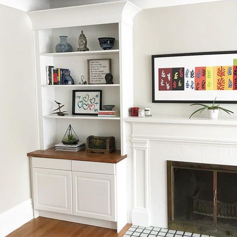 Here is a pulled back photo of the shelves I posted a few weeks ago. I really do love built ins! Here, we left the fireplace as is and added open shelving and storage around it on both sides. I love how this gives the homeowner a place to display their special things but also offers them a spot to hide and store the unsightly stuff too! It’s a win, win! Bookshelves On Either Side Of Fireplace Built Ins, Small Built In Bookcase, Vintage Fireplace With Built Ins On Both Sides, Built In Storage Around Fireplace, Adding Bookshelves Around Fireplace, Boxed In Fireplace, Fireplace Storage Ideas Built Ins, Adding Built Ins Around Fireplace, Flush Fireplace With Built Ins