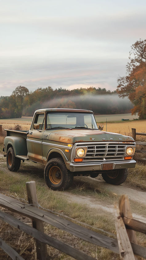 A weathered vintage Ford pickup truck in faded green and rusty hues parked by a wooden fence in a pastoral farm setting, with autumn trees and misty fields in the background, evoking a sense of rustic Americana. 1960 Ford Truck, Vintage Pick Up Trucks, Old Pick Up Trucks, Vintage Farm Truck, Old Truck Aesthetic, Old Ford Trucks Vintage, Aaa Tattoo, Old Farm Truck, Old Truck Photography