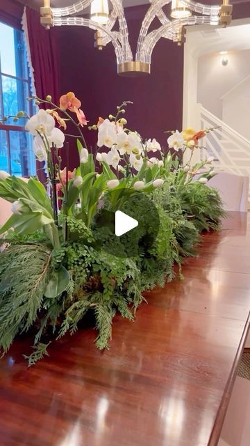 Patricia Hunt | Here is one idea for a long lasting table centerpiece!! Step by step in 40 sec. More details below:
🌿We used our waterproof florist foil to... | Instagram Low Flower Arrangements For Table, Long And Low Flower Arrangement, Potted Orchid Centerpiece, Low Flower Arrangements, Flower Arrangements For Table, Orchid Centerpieces, White Tulips, Long Table, Place Settings