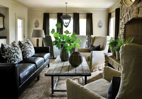 How to make leather couches cozy: team with distressed wood, linen covered wingback chairs, sizal rug and a touch of greenery to freshen it up. Black Leather Sofa Decor, Black Leather Sofa Living, Sectional Decor, Black Leather Living Room, Black Leather Furniture, Leather Sofa Decor, Black Couch Living Room, Black Sofa Living Room, Leather Sofa Living