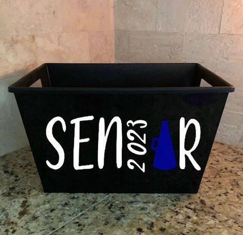 These custom Buckets are the perfect storage container or gift basket for any cheerleader! Available in a wide variety of colors for every team! This bucket is available in any sport or activity. Please send us a message if yours is not listed and we would be happy to add it for you. Plastic Rectangle Bins with Slotted Handles, 11.75x7.0x8.25 in. Senior Gift Cheerleading, Senior Cheer Gift Baskets, Cheer Baskets Cheerleading Gift Ideas, Senior Night Baskets Cheer, Senior Baskets Gift Ideas Football, Senior Cheerleader Gifts, Senior Cheer Basket Ideas, Cheerleader Senior Night Gifts, Cheer Senior Night Gifts Baskets