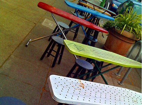 Vintage ironing boards used as outdoor tables! Yes, they’re a little narrow, but they’re colorful and sturdy ! Ironing Board Tables, Vintage Ironing Boards, Old Ironing Boards, Wooden Ironing Board, Ironing Boards, Restaurant Ideas, Pallet Outdoor, Black Chair, Booth Ideas