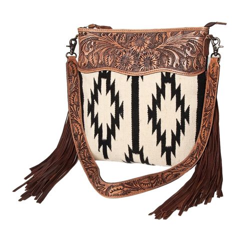 PRICES MAY VARY. American Darling is a proud OFFICIAL DESIGNER SPONSORS OF NEW YORK FASHION WEEK 2024 PREMIUM QUALITY MATERIAL: This is a handmade American Darling women's signature crossbody bag made with hand-weaved woolen saddle blanket fabric that gives it a traditional Western yet trendy and elegant look. High-quality soft and supple Eco friendly vegetable-tanned full grain Genuine leather and Hand tooled, carved, Eco friendly vegetable-tanned Cowhide Leather are also used to make this hand Louis Vuitton Western Purse, Western Christmas Wishlist, American Darling Purse, Country Christmas List, Western Purses And Handbags, Western Leather Purse, Western Bags Purses, Western Bags, Western Bag