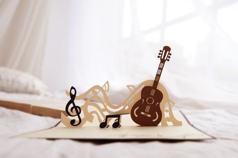 Classic Guitar Pop Up Card Classic guitar pop up card has a gold cover featuring a classic guitar. Once opened a beautiful three-dimensional guitar pops out of the greeting card, and surprise any lucky recipients. We always leave the card blank so that you can personalize your own words. #Popupcardwholesale #popupcardmanufacture #popupcardsmanufacture #popupcards  #popupcardsupplier #charmpopcards #classic #guitar Guitar Pop Up Card, Fondant Olaf, 3d Pop Up Cards, Music Cards, Diy Pop Up Cards, Birthday Music, Tarjetas Pop Up, Simple Birthday Cards, Music Paper