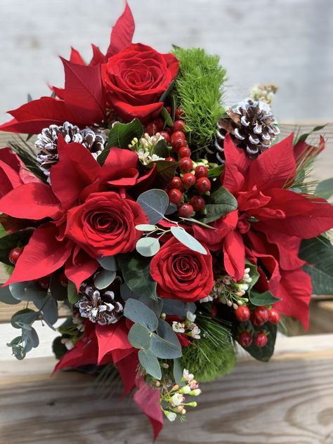 Winter bouquet with roses , pine cones, hypericum berries, and poinsettias Christmas Bridal Bouquet Cascading, Pointsetta Bouquet, Christmas Flower Bouquet, Poinsettia Wedding, December Bride, Hallmark Wedding, Poinsettia Bouquet, Winter Bouquets, Christmas Wedding Bouquets