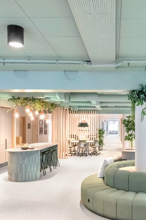 Co-working space in Oslo, Norway, that has soft pink walls, light blue ceilings, and sage green couches in the center, with decorative indoor plants. Water Office Design, Office Interior Design Ceiling, Welcome Area Office, Coastal Modern Office, Co Working Space Design Interiors, Sage Green Office, Office Collaboration Space, Industrial Color Palette, Office Ceiling Design