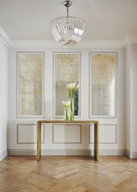 Antique mirror panels with bronze and Art Deco details on classic Green park apartment in London with wooden floors and flowers in a vase. Tiles Interior Design, Eglomise Mirror, Mirror Panel Wall, Chateaux Interiors, Interior Design Masters, Mirror Panel, Mirror Panels, Luxury Tile, Decorative Tiles