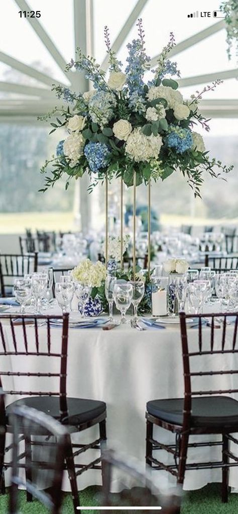 Blue Wedding Venue Decorations, Icy Blue And Navy Wedding, Wedding Floral Arrangements Blue, Navy Floral Centerpieces, Wedding Table Decor Blue And White, Dusty Blue Winter Wedding Table Settings, Navy Blue Flower Centerpieces, Floral Centerpieces For Round Tables, Gold White And Blue Wedding