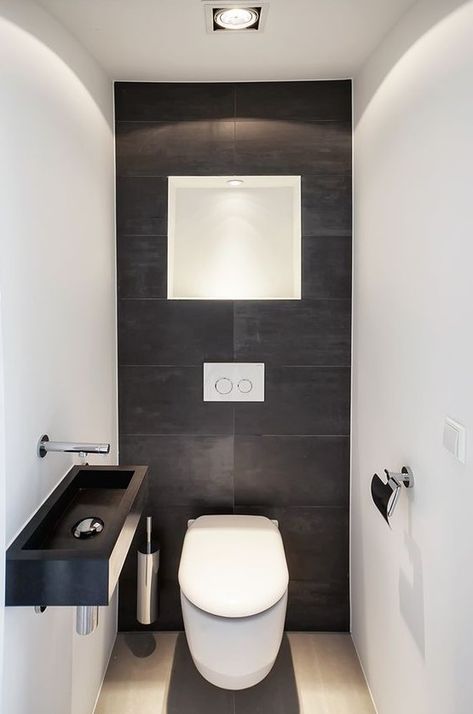 a minimalist guest bathroom with black and white tiles of different sizes, a black wall mounted sink and some lights Small Full Bathroom Layout, Bathroom Remodel Design Ideas, Office Bathroom Design, Small Downstairs Toilet, Small Full Bathroom, Small Bathroom Remodel Designs, Small Toilet Room, Guest Toilet, Modern Toilet