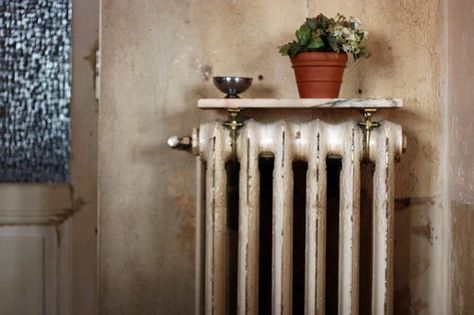 Radiators can take up quite a bit of space in a small apartment. But do you know what helps? Resting a shelf on top. Make sure you aren't storing books or flammable objects there, but think of it as a warming side table where you can perch a cup of joe when you're curled up on the sofa! Here are a few examples: Radiator Topper, Shelf Over Radiator, Granite Shelf, Tv Room Furniture, Radiator Table, Cottage Hallway, Old Radiators, Radiator Shelf, Beautiful Home Designs