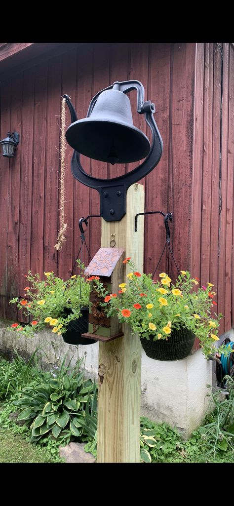 Yard Bell Ideas, Round Fence Post Crafts, Flag Post Ideas, Dinner Bell Post, Fence Post Crafts, Cast Iron Bell, Post And Beam Barn, Themed Garden, Patio Deck Designs