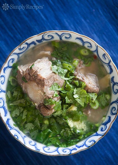 Hawaiian Oxtail Soup ~ Hawaiian oxtail soup with oxtails, slowly cooked to produce their own broth, with ginger, anise, orange peel, peanuts, chili, mustard greens, onions, and cilantro. ~ SimplyRecipes.com Hawaiian Oxtail Soup Recipe, Nutribullet Soup Recipes, Oxtail Soup Recipe, Instapot Soup Recipes, Sliced Ginger, Whole30 Soup Recipes, Ox Tail, Oxtail Soup, Oxtail Recipes