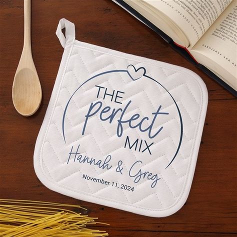 Personalize with names and line of textChoose from multiple colors White, cotton potholder features concentrated quilt patterns to keep the filling material evenly distributed, even after repeated washingsLined with silver acrylic coated cottonMeasures 8" x 8"Machine washSold IndividuallyImported Celebrate your new married status in the kitchen with our The Perfect Mix Personalized Apron & Potholder.  Makes a great bridal shower, wedding or anniversary gift! Personalized Kitchen Items, Cricut Wedding Gifts, Personalized Kitchen Towels, Personalized Apron, Cricut Supplies, Cricut Wedding, Quick Crafts, Personalized Kitchen, Personalized Aprons