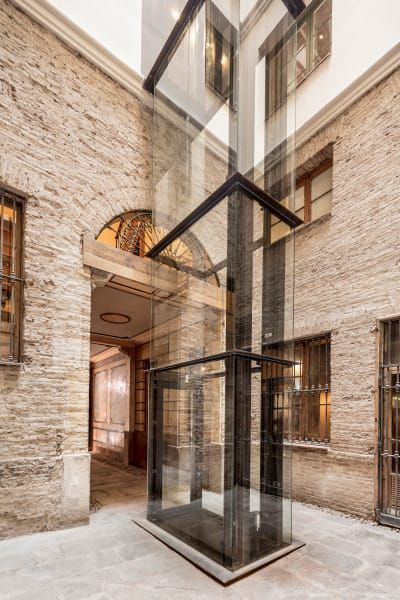 Agora Arquitectura, Adrià Goula · OPENING DOORS TO THE CITY · Divisare Stair Lift, Glass Lift, Renovation Architecture, Elevator Design, Glass Elevator, Santa Isabel, Glass Structure, Lift Design, Opening Doors