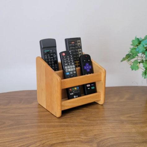 Here is a solid wood vintage remote control caddy. Approximately outer measurements 6.5 inches tall x 5.25 inches deep x 7 inches long. Front slot opening 2 inches wide and 4 inches deep, back slot opening 1.5 inches wide and 4.75 inches deep. Diy Wood Pallet Projects, Remote Control Storage, Wooden Desk Organizer, Remote Control Holder, Remote Holder, Funny Post, Letter Holder, Diy Holder, Bedroom Furniture Design