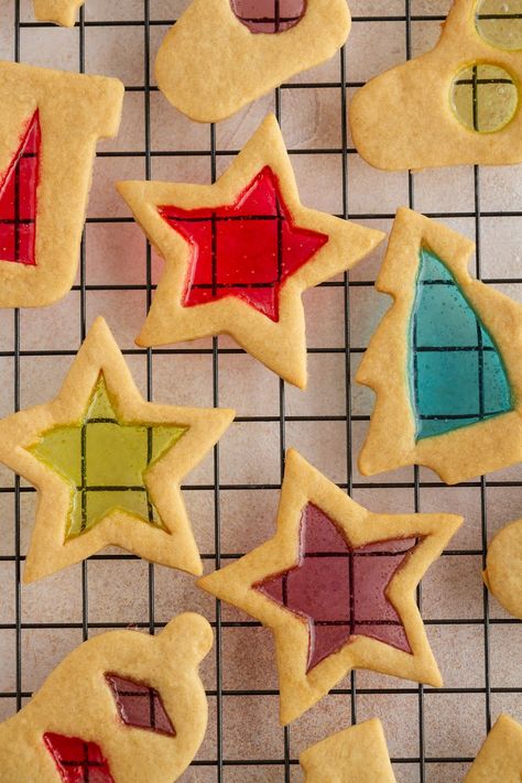 hese Stained Glass Window Cookies are both stunning and simple: the perfect combination. A super-forgiving sugar cookie dough with a kiss of molasses is baked with centers of crushed candies and decorated with icing for a fun, festive and straightforward cookie recipe you'll want to bake year after year. Stained Glass Window Cookies Recipe, Glass Window Cookies, Window Cookies, Glass Cookies, Chocolate Macadamia Nut Cookies, Easy Icing, White Chocolate Macadamia Nut Cookies, White Chocolate Macadamia Nut, Stained Glass Cookies