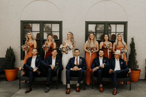 Rust Wedding Theme Groomsmen, Burnt Orange Wedding Attire, Burnt Orange And Navy Bridal Party, Wedding Party Photos Navy Suits, Burnt Orange Bridesmaid Dresses With Groomsmen, Terracotta And Navy Wedding Bridesmaid Dress, Rust Wedding Attire, Orange Bridesmaid Dresses With Groomsmen, Navy And Burnt Orange Groomsmen