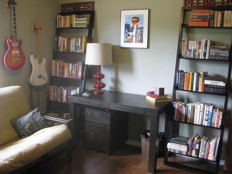 Office Music Room Combo, Office Guest Room Layout, Guest Room Layout, Playroom Guest Room Combo, Guest Room Futon, Media Shelving, Room Futon, Slanted Shelves, Guest Room Office Ideas