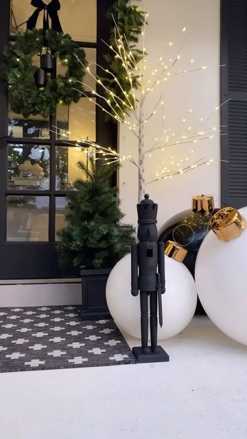 Juani  •  Modern Home Decor + Lifestyle on Instagram: "Lots of requests for this from porch decor✨  Sharing early because these items sell out!  I plan on recreating this Christmas front porch decor from last year. I loved the simplicity of it and how magical it felt at night ✨  Follow and comment LINKS for direct links sent to you 🖤  You can always shop my posts on the LTK app. Follow @the_sip_studio for all of my links and app exclusive content 🫶🏻  #christmasdecor #christmas #christmasdiy #nutcracker #nutcrackers #nutcrackerseason #homedecor #christmastime #christmasinspo #neutralchristmas #ltk #ltkhome #myhomevibe #christmaslights #frontporch #frontporchdecor #diy" Scandi Outdoor Christmas Decorations, Christmas Porch Decor Modern, Modern Outdoor Holiday Decor, Black Christmas Porch Decor, Black And White Outdoor Christmas Decor, Modern Nutcracker Christmas, Modern Christmas Entryway, Porch Post Christmas Decorations, Modern Christmas Porch Decor