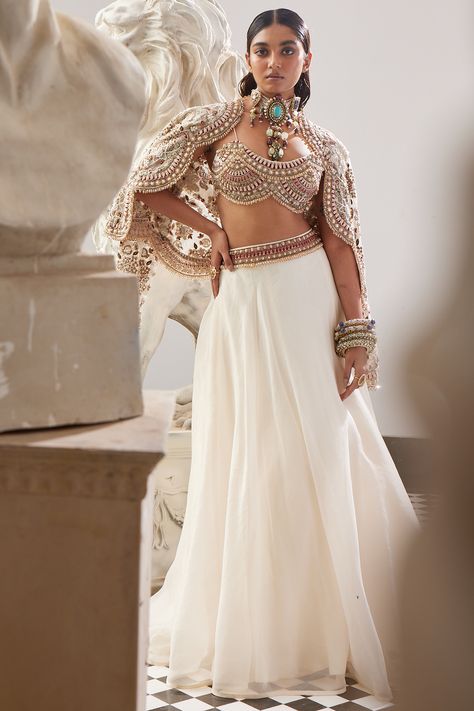 This occasion-ready ivory lehenga in organza is complemented with a matching flat chiffon jewelled blouse and a 3D floral bomber. Style the look with dangler earrings and heels for a sangeet, engagement or wedding ceremony. Perfect wear for a bridesmaid. #perniaspopupshop #whatiworewastrending #ppuslove #ridhimabhasin #rakhi #teej #festivewear #ivoryorganza&chiffonjacket #lehengaset #lehenga #chiffonlehenga #weddingceremony #sangeetoutfits Wedding Embellished Organza Choli, Bollywood Style Organza Blouse With Cutdana, Fitted Bollywood Organza Blouse, Semi-stitched Organza Lehenga With Pearl Embroidery, White Embellished Organza Lehenga, Chiffon Lehenga, Onam Outfits, Jacket Lehenga, Ridhima Bhasin