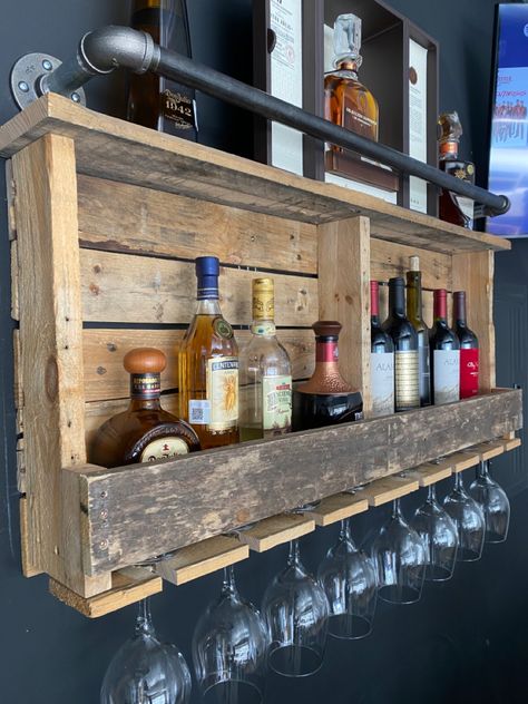 This was made out of pallets and plumbing pipe. Mix of industrial rustic decor for a garage bar or man cave Pallet Bar Shelves, Outdoor Bar Shelf, Diy Bar In Garage, Rustic Bar Cabinet Ideas, Rustic Man Cave Bar, Rustic Garage Bar Ideas, Garage Bar Decor, Vintage Home Bar Ideas, Man Cave Garage Diy