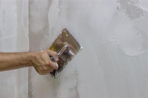 man hand with trowel plastering a wall How To Stucco, Cinder Block Garden Wall, Basement Wall Colors, Cinder Blocks Diy, Stucco Fireplace, Cinder Block Garden, Concrete Block Walls, Cinder Block Walls, Man Hand