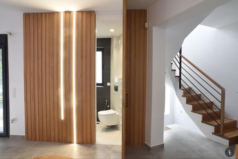 Wood panel stripped wall with hidden door with bathroom inside and led gramic stripped neon lights. Wall Panel Hidden Door, Panel Hidden Door, Wall With Hidden Door, Stripped Wall, Door Bathroom, Hidden Door, Neon Lights, Wood Panel, Wall Panel