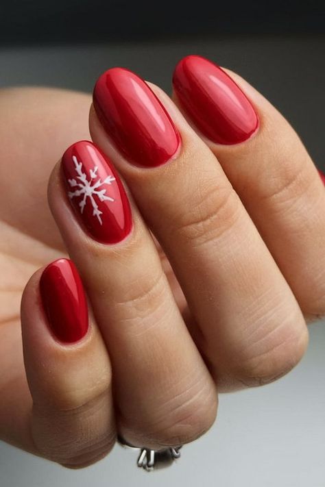 A simple yet elegant red nail design with a white snowflake on the ring finger, perfect for the holiday season. The glossy red finish adds a vibrant touch, while the snowflake art brings in the winter spirit. Red Nails With Snowflake, Nails With Snowflake Design, Red Nail Design, Christmas Snowflakes Nails, Snowflake Art, Xmas Nail Designs, Ring Finger Nails, Red Gel Nails, Holiday Nails Winter