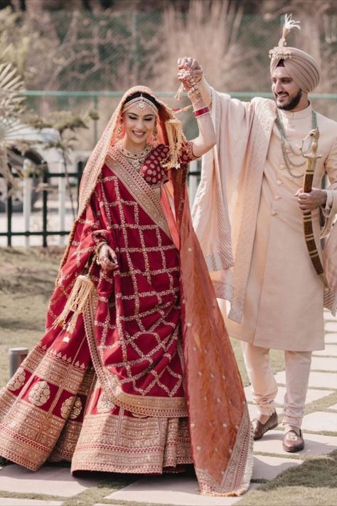 Sikh bride in a deep red Sabyasachi lehenga with the groom in an Ivory outfit भारतीय दुल्हन संबंधी, Best Indian Wedding Dresses, Indian Wedding Lehenga, Groom Dress Men, Indian Groom Wear, Wedding Dresses Men Indian, Latest Bridal Lehenga, Couple Wedding Dress, Wedding Lehenga Designs